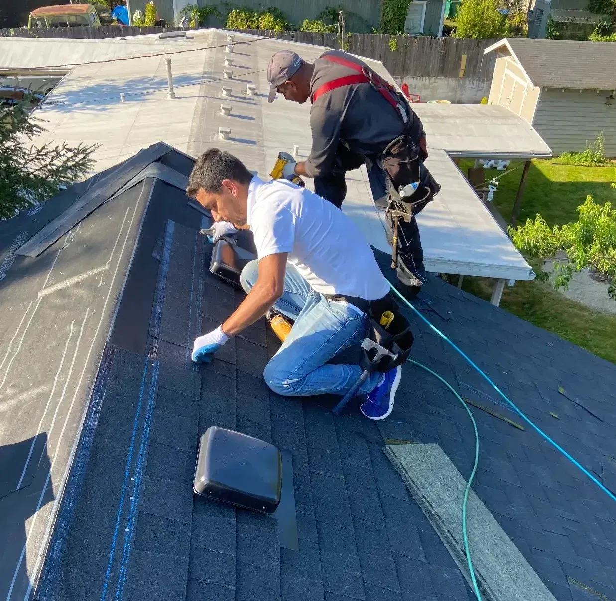 Roofing crew working on a shingle installation
